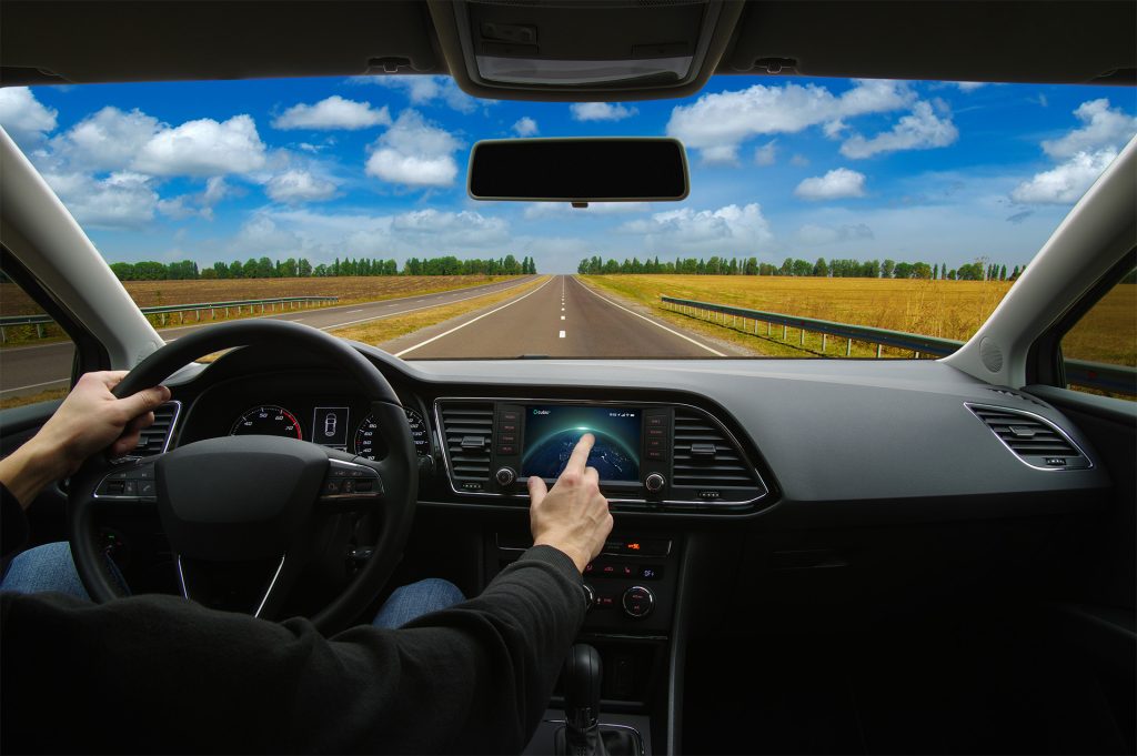 driver in car interacting with a touch screen