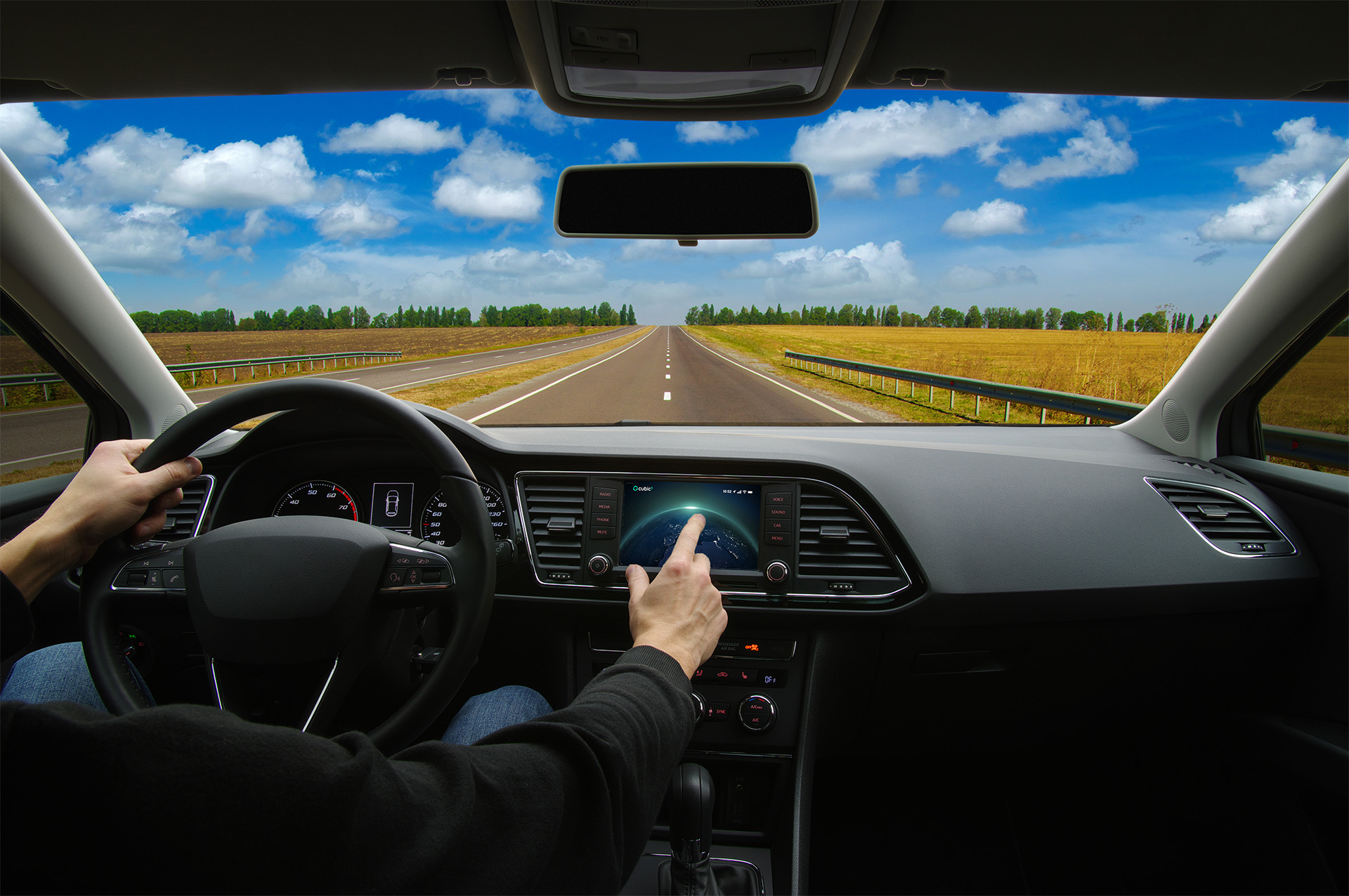 driver in car interacting with a touch screen