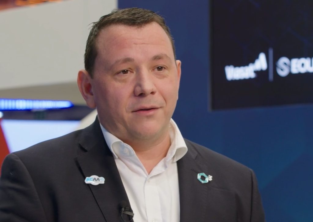 ndré Schlufter, Director of Automotive Connectivity Innovation at Cubic<sup>3</sup>, speaking at MWC 2026